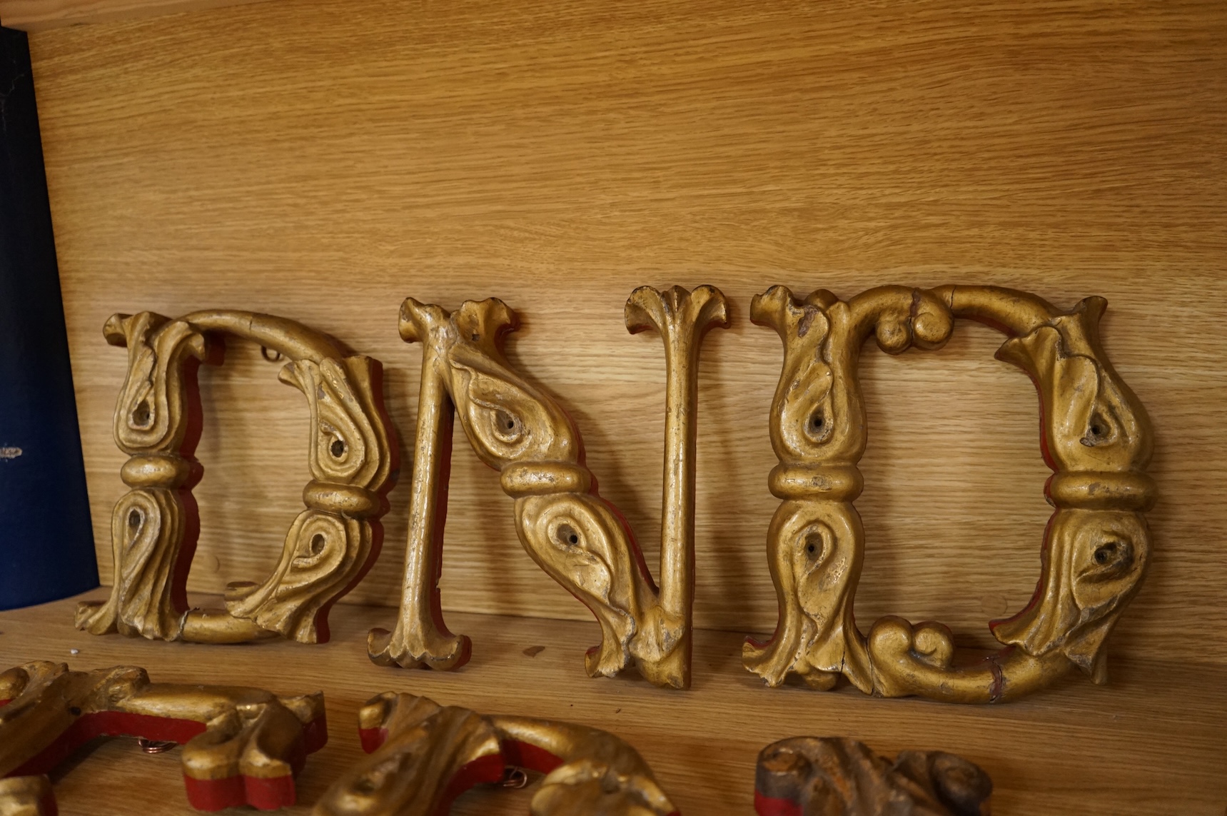 A quantity of decorative carved, painted and gilt carnival letters, each approximately 23cm high